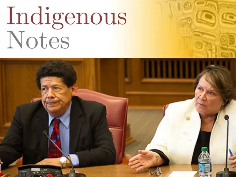 The text shows a man with dark hair in a suite, and a woman with blond hair and a white blazer. The text reads: Indigenous Notes.
