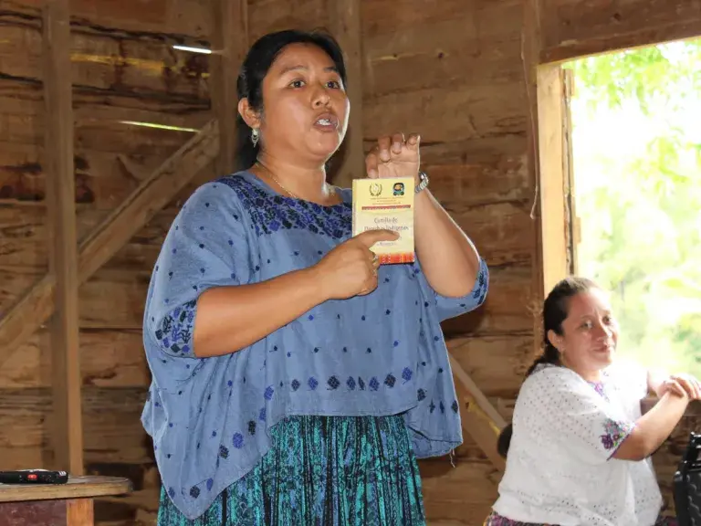 Matilde Chocooj Coc stood talking to the mayor and town council members of Crique Sarco, a Q’eqchi Maya. Photo provided by Cultural Survival