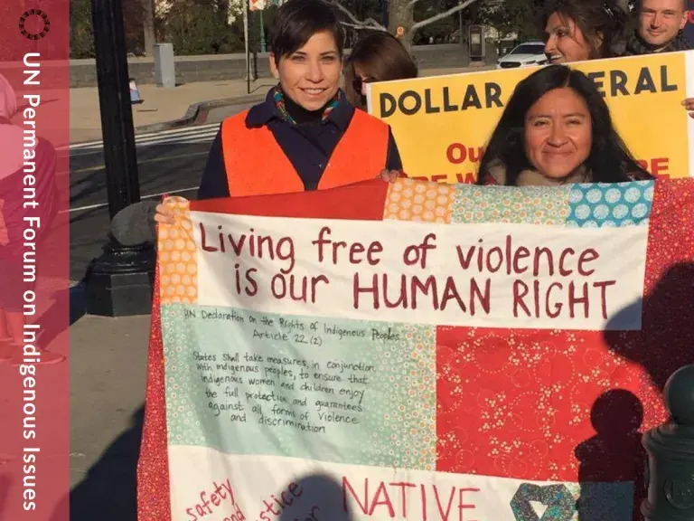 Image features ILRC staff with a sign that reads &quot;living free of violence is our human right&quot;